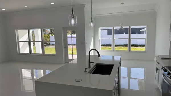 a kitchen with a sink a counter top space and stainless steel appliances