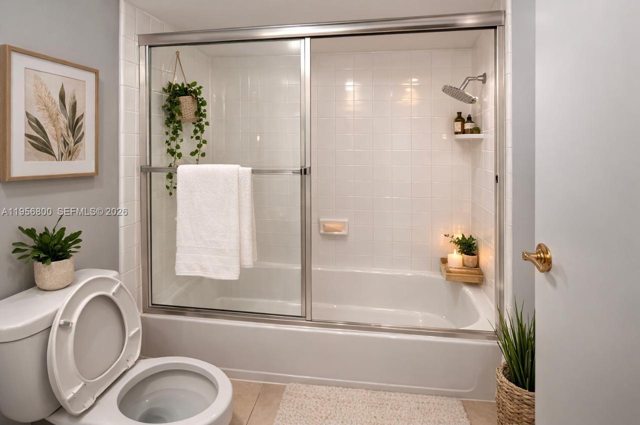 850 Southwest 129th Place, Unit 103 Miami, FL 33184 - Photo 3 of 8 a bathroom with a tub and a shower