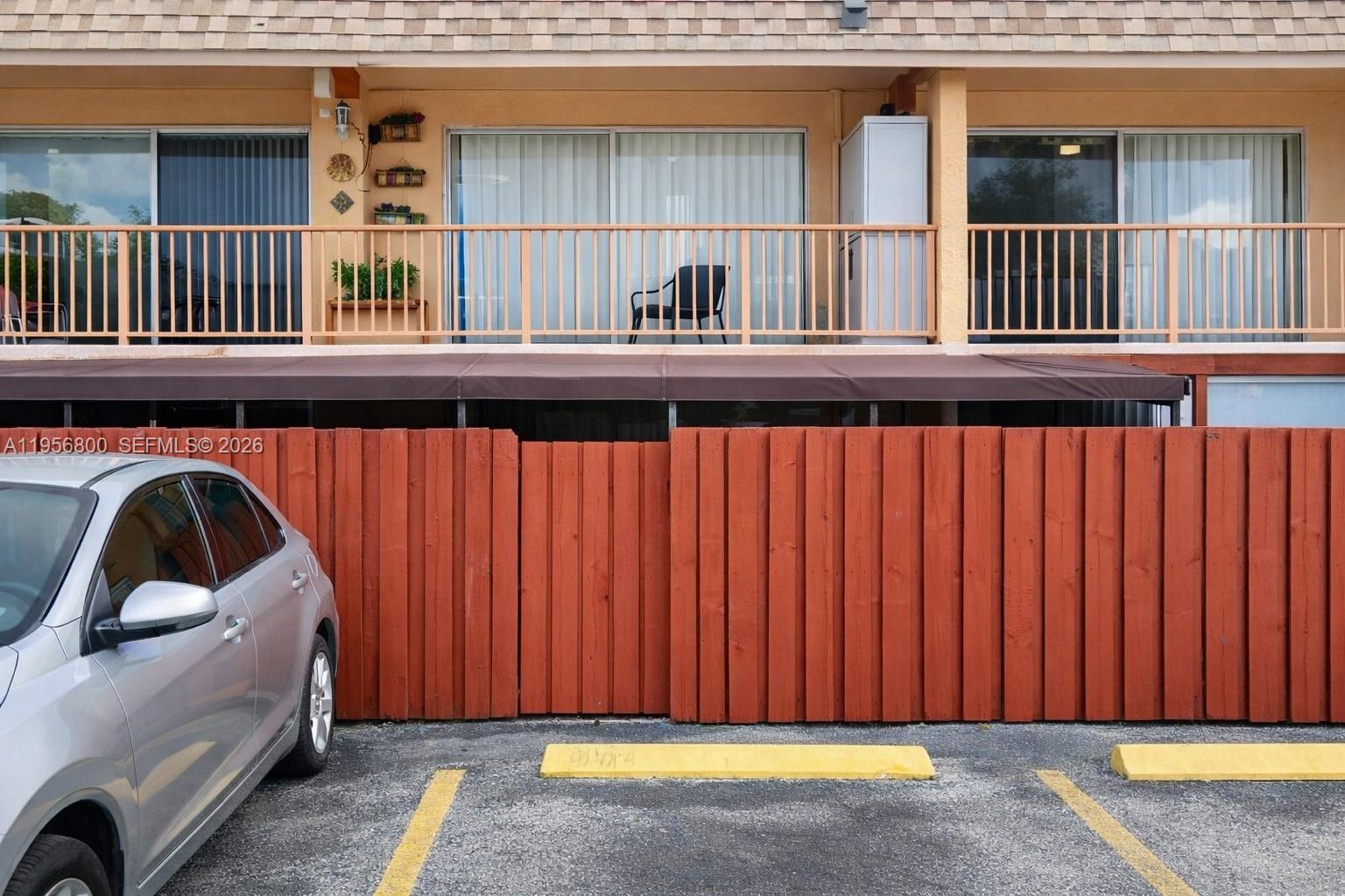 850 Southwest 129th Place, Unit 103 Miami, FL 33184 - Photo 7 of 8 a view of a car parked in front of a house