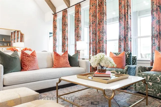 a living room with furniture and large windows