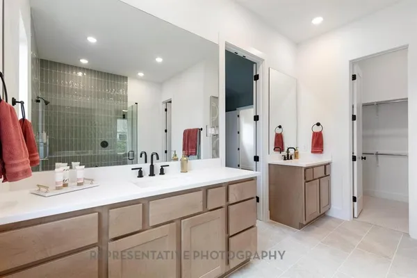 a bathroom with a sink double vanity and a mirror