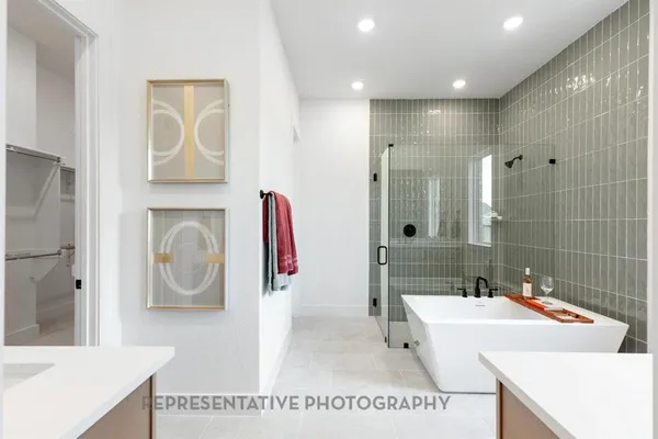 a bathroom with a sink a tub and a mirror