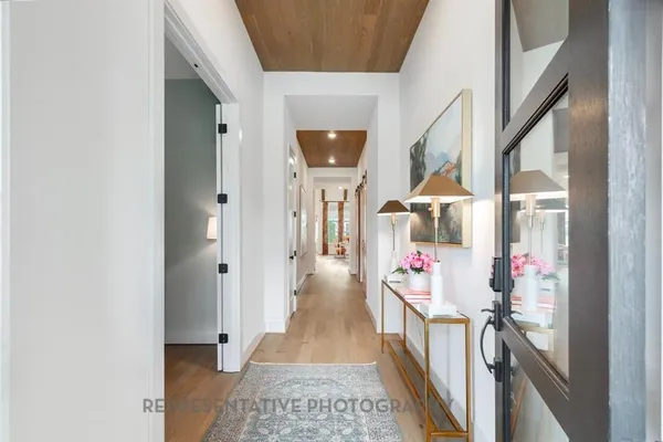 a hallway with beautiful frames and flower pot
