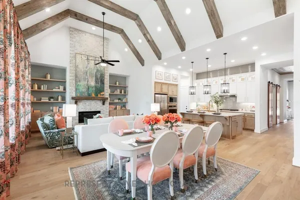 a large kitchen with a table and chairs