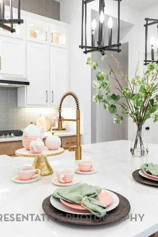a vase of flowers sitting on a table with white walls