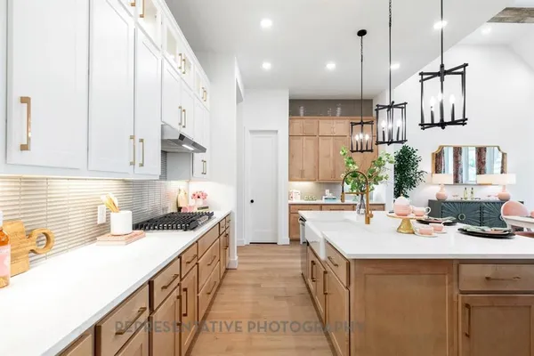 a kitchen with a sink stove and cabinets