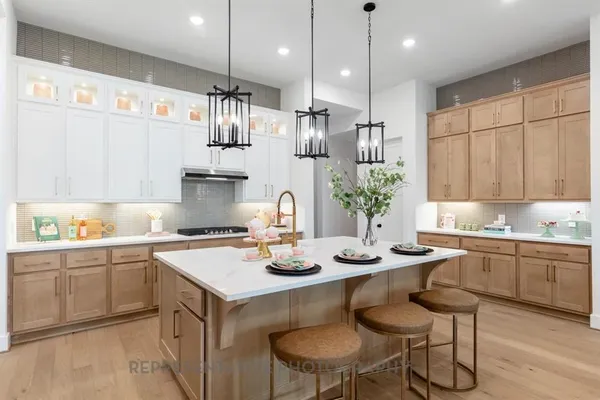 a kitchen with stainless steel appliances kitchen island granite countertop a sink and cabinets