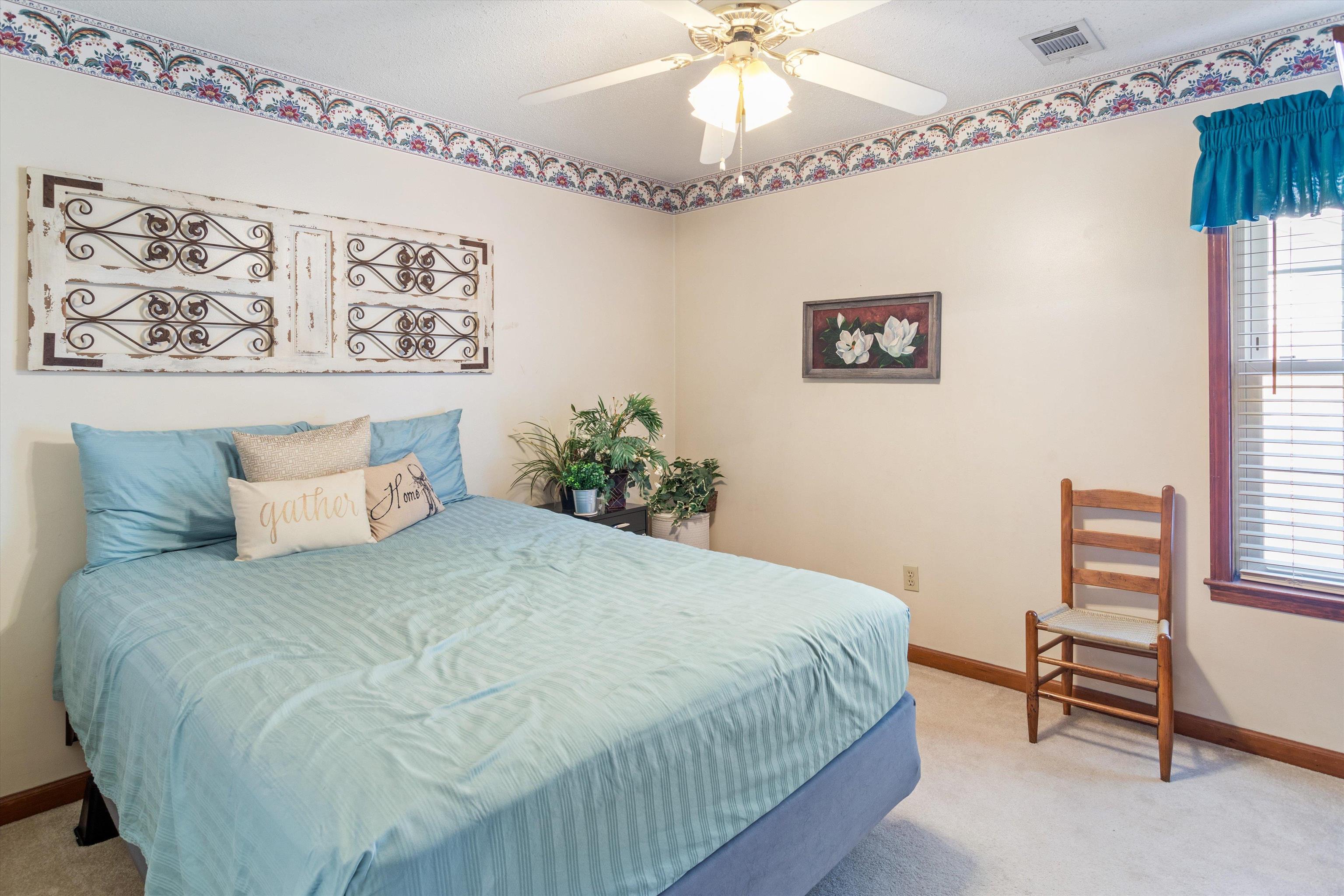509 Shelton Road Collierville, TN 38017 - Photo 15 of 21 a bedroom with a bed and a chandelier