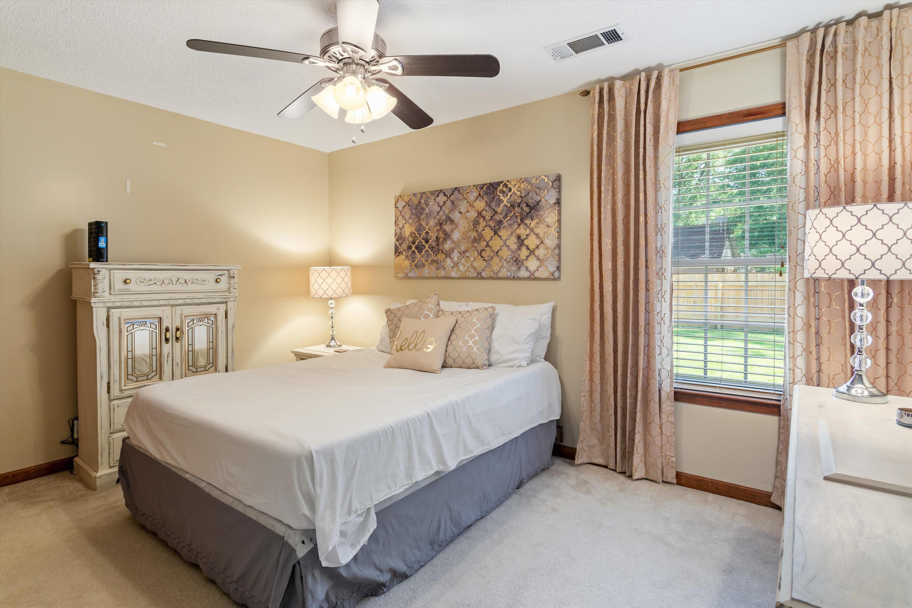 509 Shelton Road Collierville, TN 38017 - Photo 17 of 21 a bedroom with a bed and a chandelier
