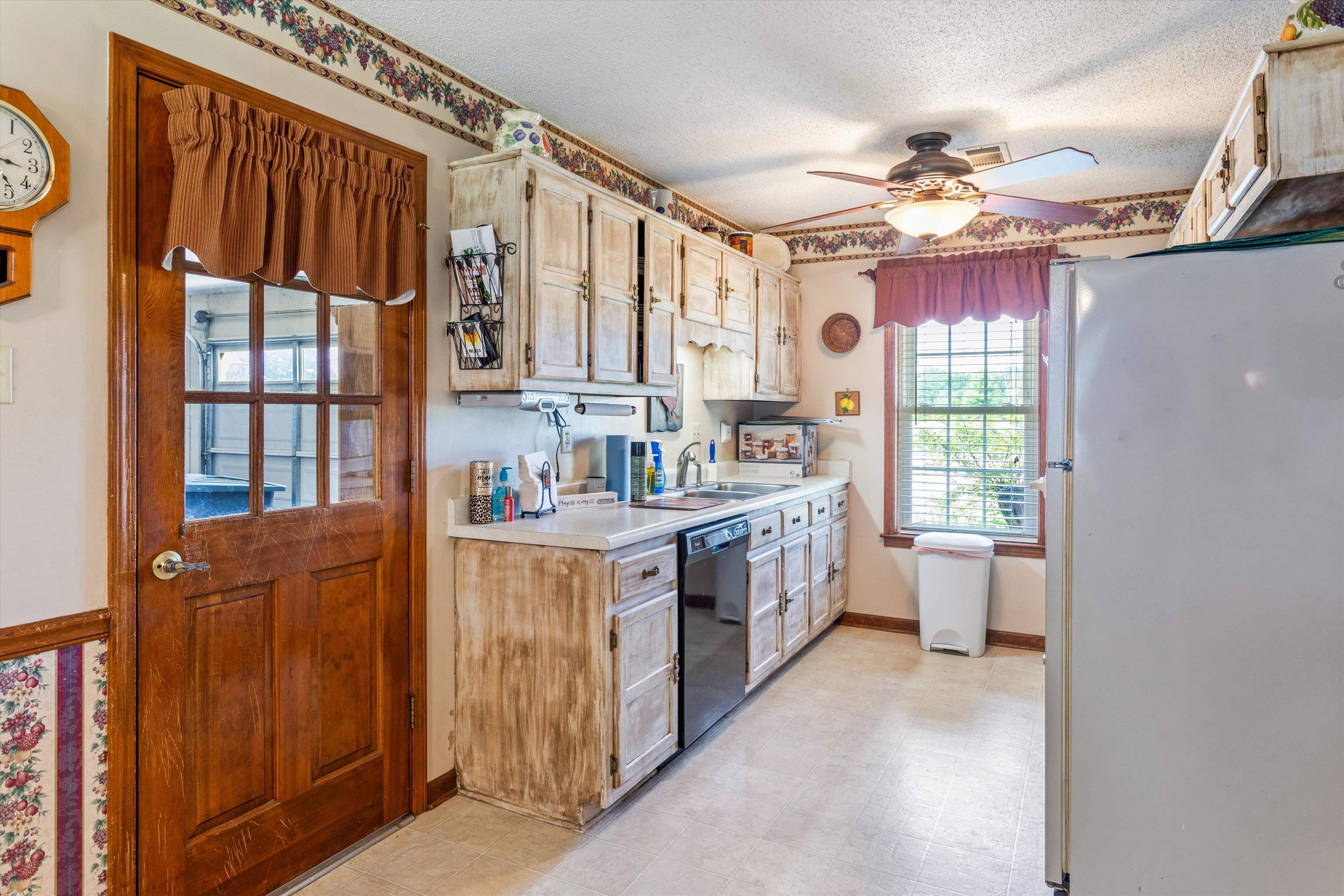 509 Shelton Road Collierville, TN 38017 - Photo 7 of 21 a kitchen with kitchen island granite countertop a refrigerator oven a sink dishwasher and white cabinets with wooden floor