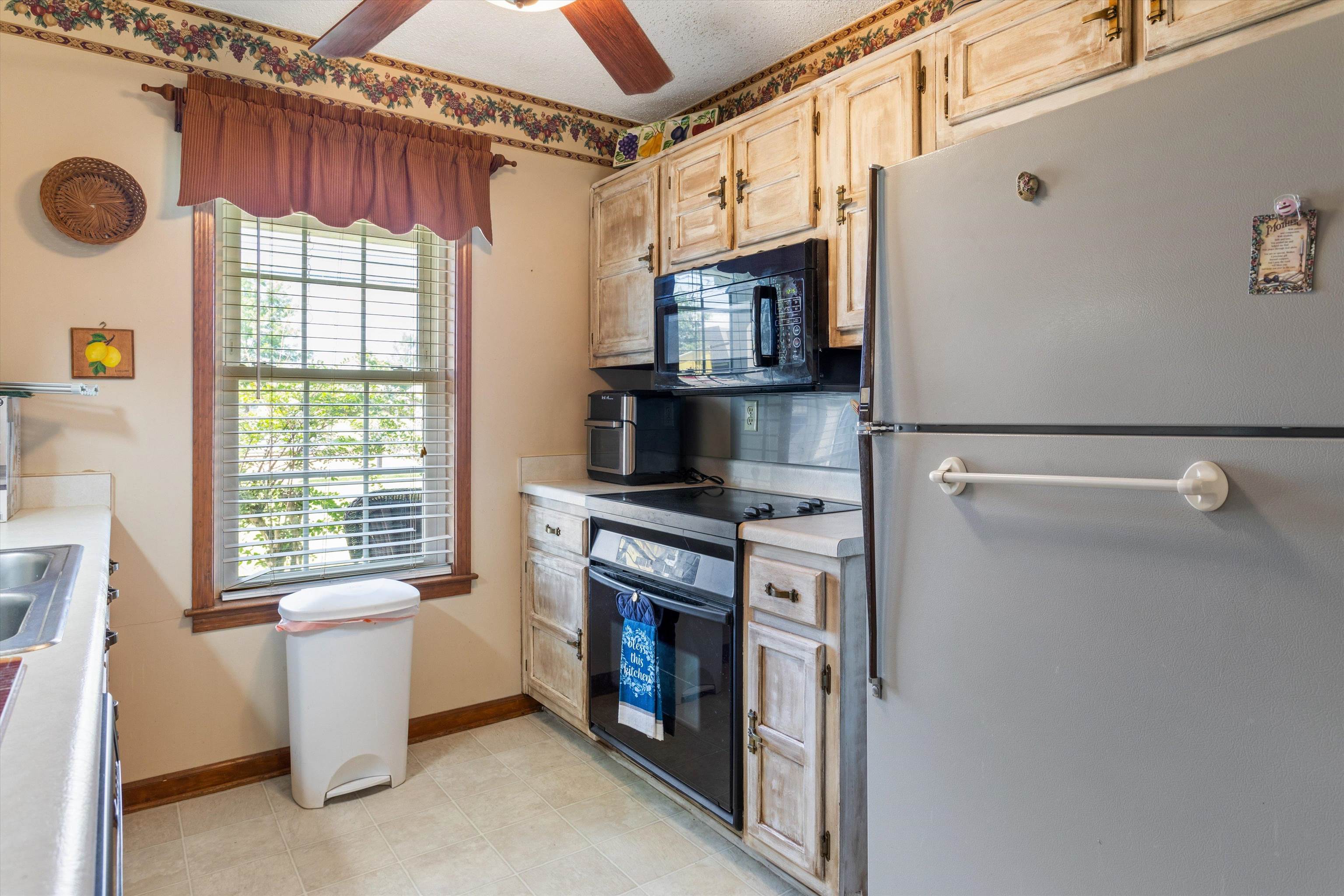 509 Shelton Road Collierville, TN 38017 - Photo 9 of 21 a kitchen with a refrigerator a stove a microwave and a window
