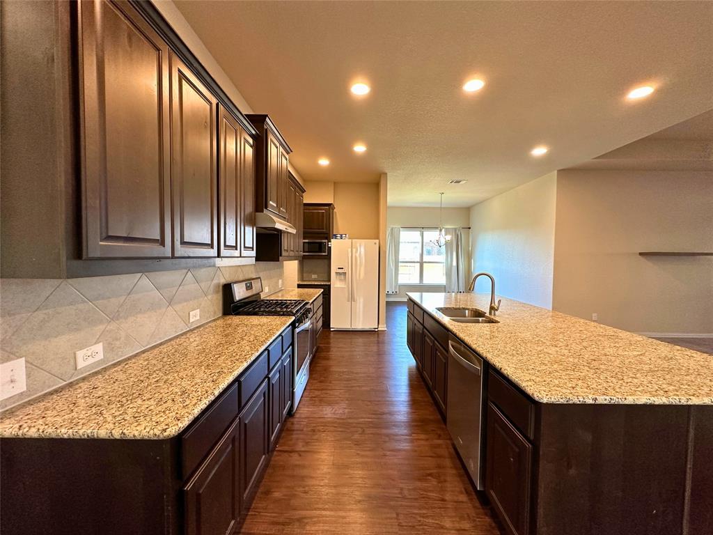 3117 Hidalgo Loop Round Rock, TX 78665 - Photo 9 of 27 a large kitchen with stainless steel appliances granite countertop plenty wooden cabinets