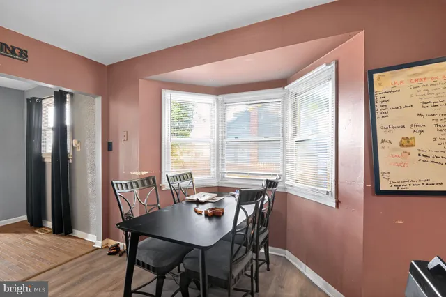 a bedroom with a bed and dresser with window