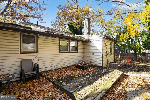 a view of a small house with a tree in the background
