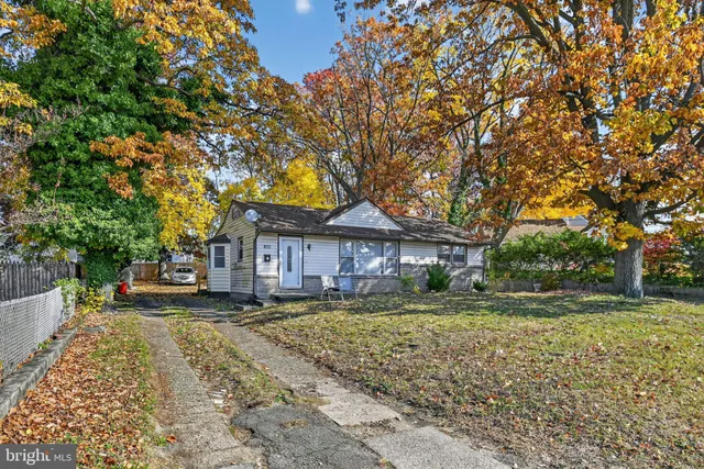 a house that has a tree in front of it