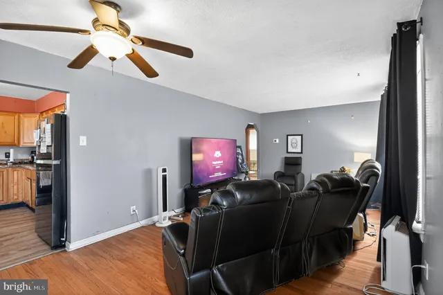 a kitchen with stainless steel appliances granite countertop a stove a sink dishwasher and a microwave oven with wooden floor