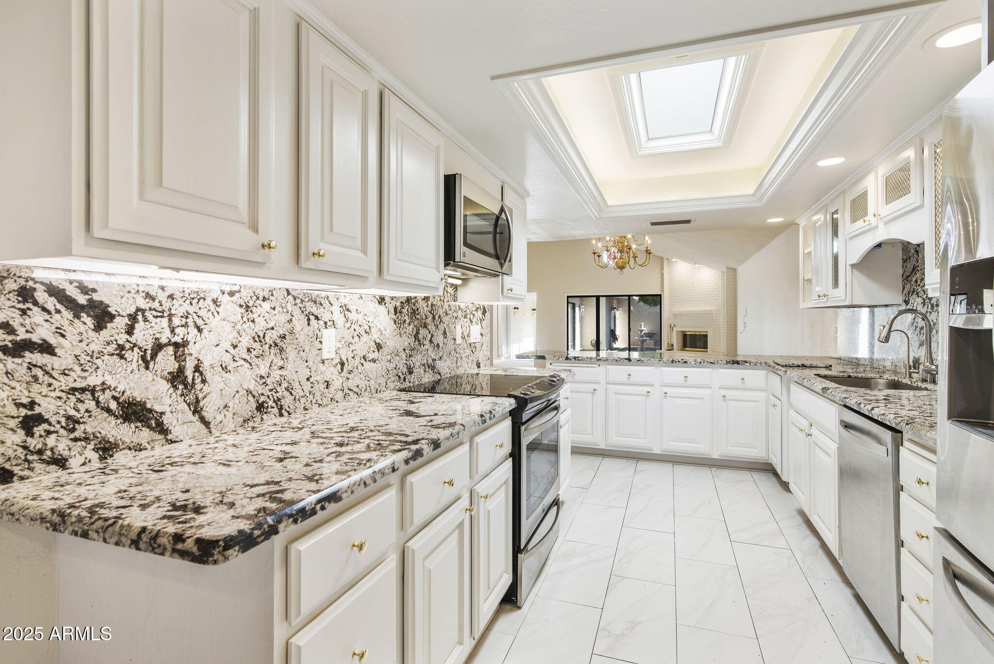 7365 East Valley View Road Scottsdale, AZ 85250 - Photo 11 of 45 a kitchen with stainless steel appliances granite countertop a sink and cabinets