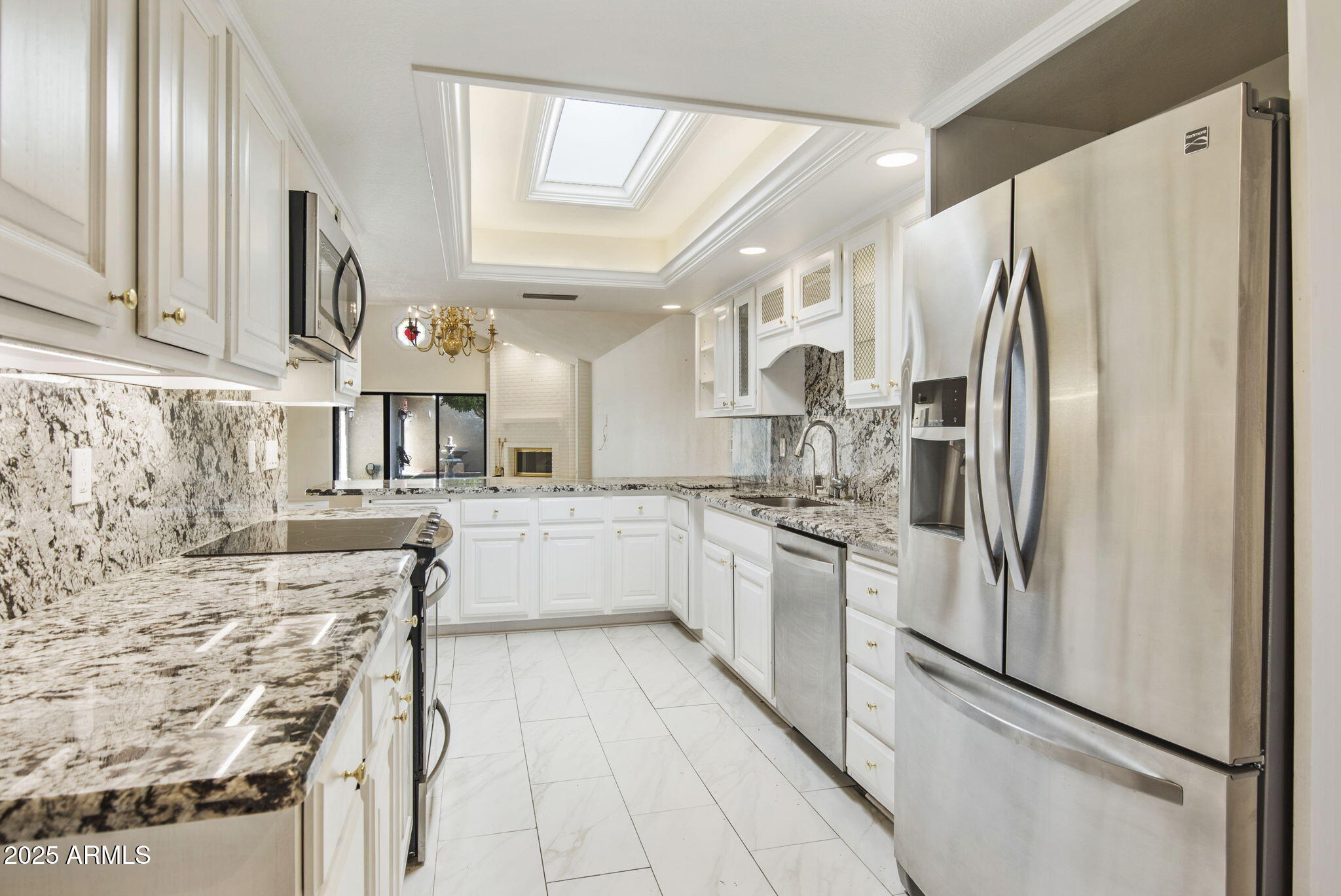 7365 East Valley View Road Scottsdale, AZ 85250 - Photo 12 of 45 a kitchen with stainless steel appliances granite countertop a refrigerator a stove and a sink