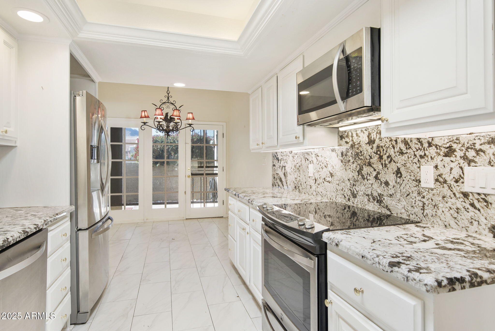 7365 East Valley View Road Scottsdale, AZ 85250 - Photo 13 of 45 a kitchen with granite countertop a sink stainless steel appliances and cabinets