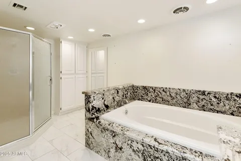 a bathroom with a granite countertop sink a mirror and a vanity