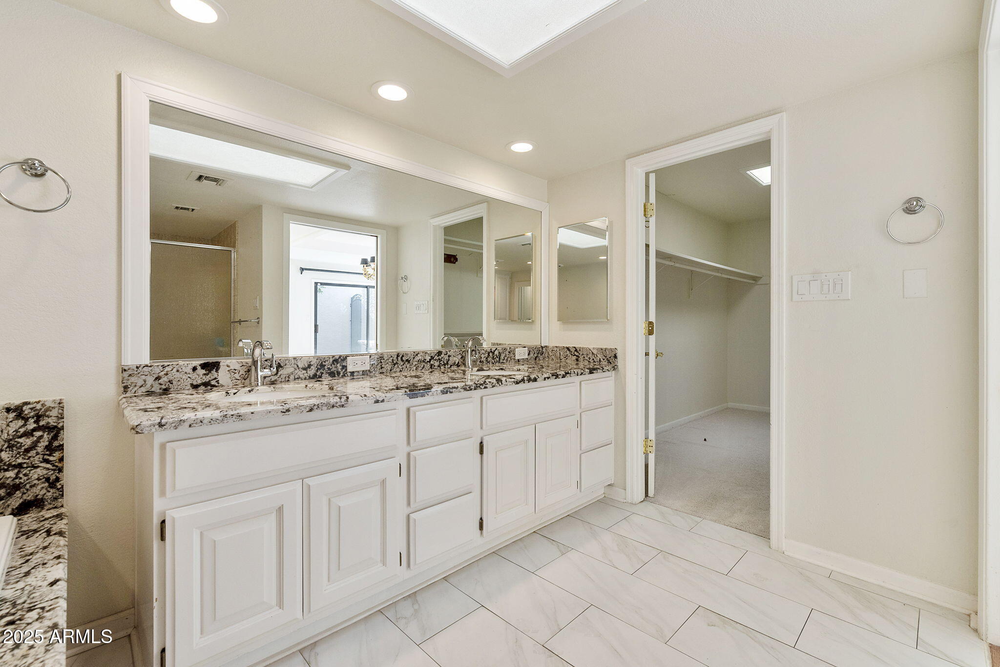 7365 East Valley View Road Scottsdale, AZ 85250 - Photo 24 of 45 a bathroom with a granite countertop sink a mirror and a vanity