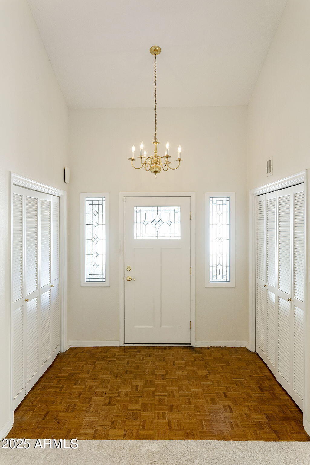 7365 East Valley View Road Scottsdale, AZ 85250 - Photo 29 of 45 a view of a livingroom with a chandelier fan and windows
