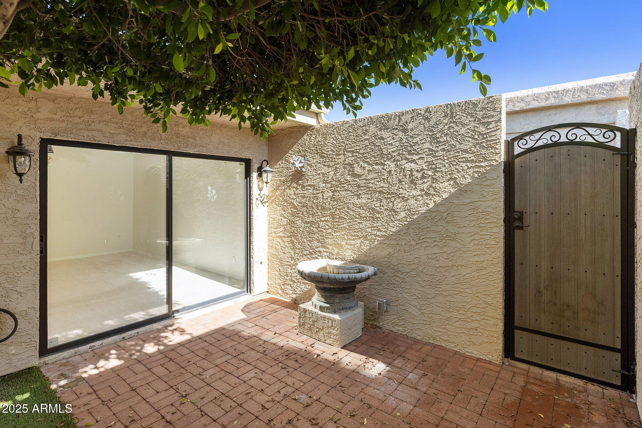 7365 East Valley View Road Scottsdale, AZ 85250 - Photo 32 of 45 a view of a porch with a floor to ceiling window and wooden floor