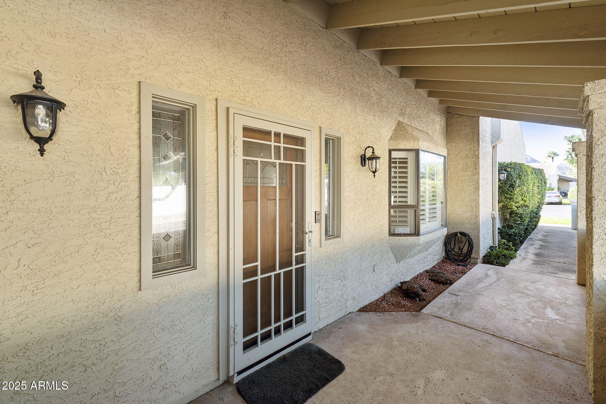 7365 East Valley View Road Scottsdale, AZ 85250 - Photo 35 of 45 a view of a porch with wooden floor and windows