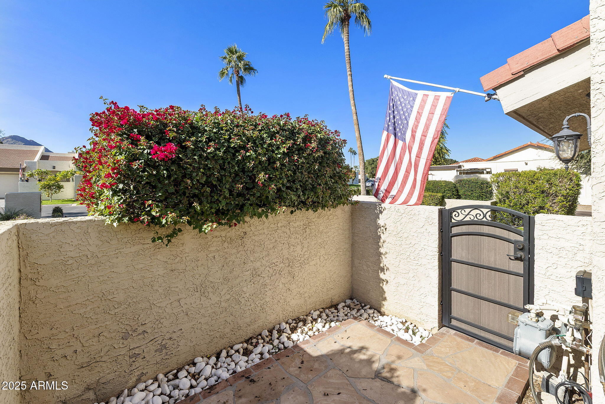 7365 East Valley View Road Scottsdale, AZ 85250 - Photo 37 of 45 a view of a house with a flower garden