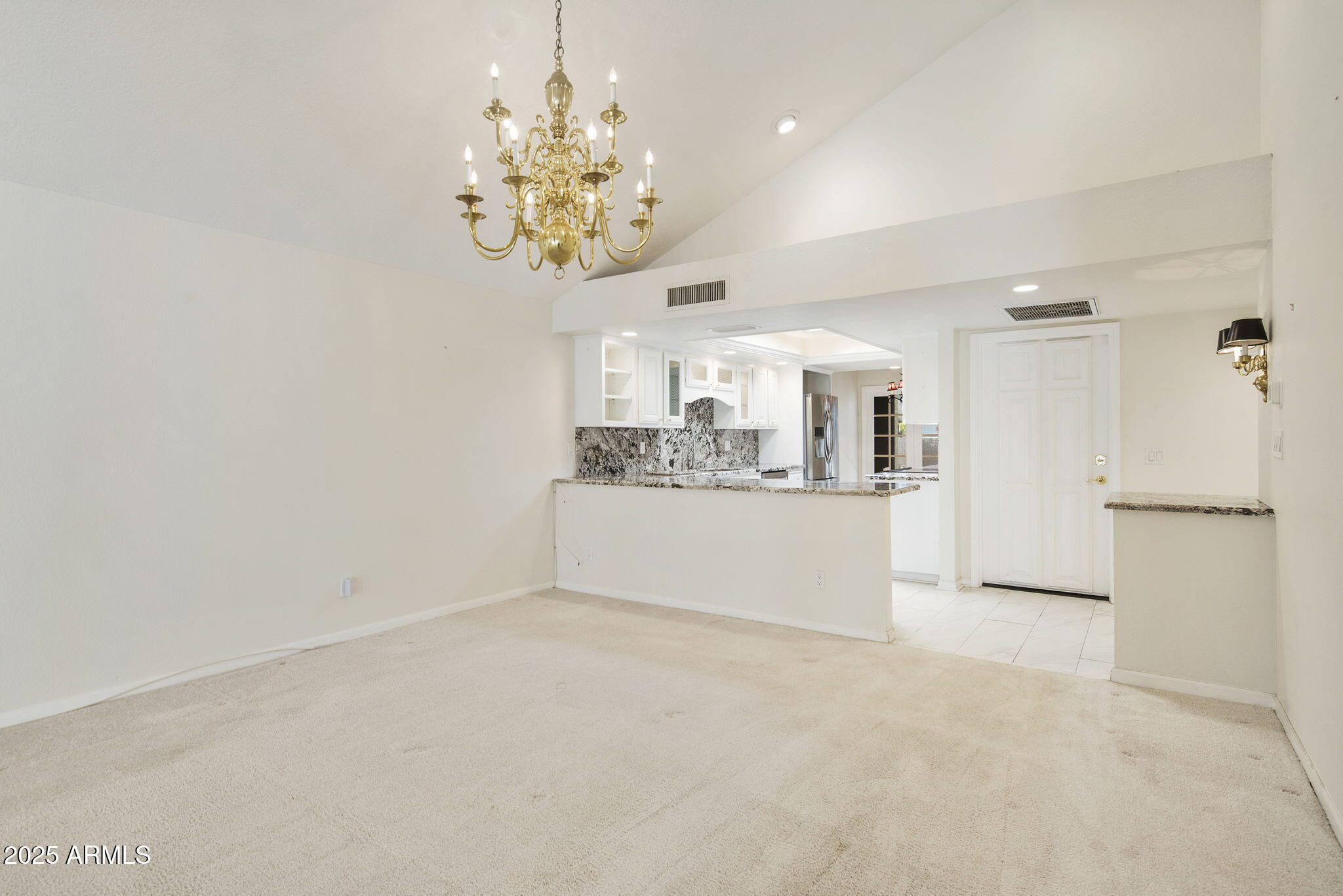 7365 East Valley View Road Scottsdale, AZ 85250 - Photo 4 of 45 a view of a hallway with a chandelier