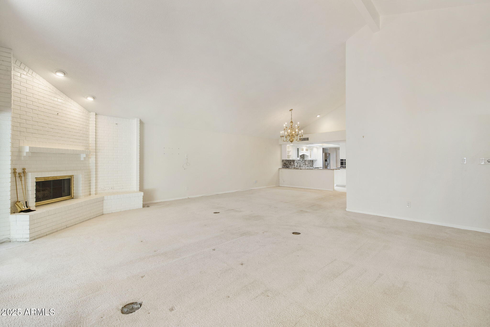 7365 East Valley View Road Scottsdale, AZ 85250 - Photo 45 of 45 an empty room with a fireplace and chandelier fan