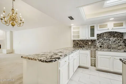 a kitchen with stainless steel appliances granite countertop a sink and cabinets