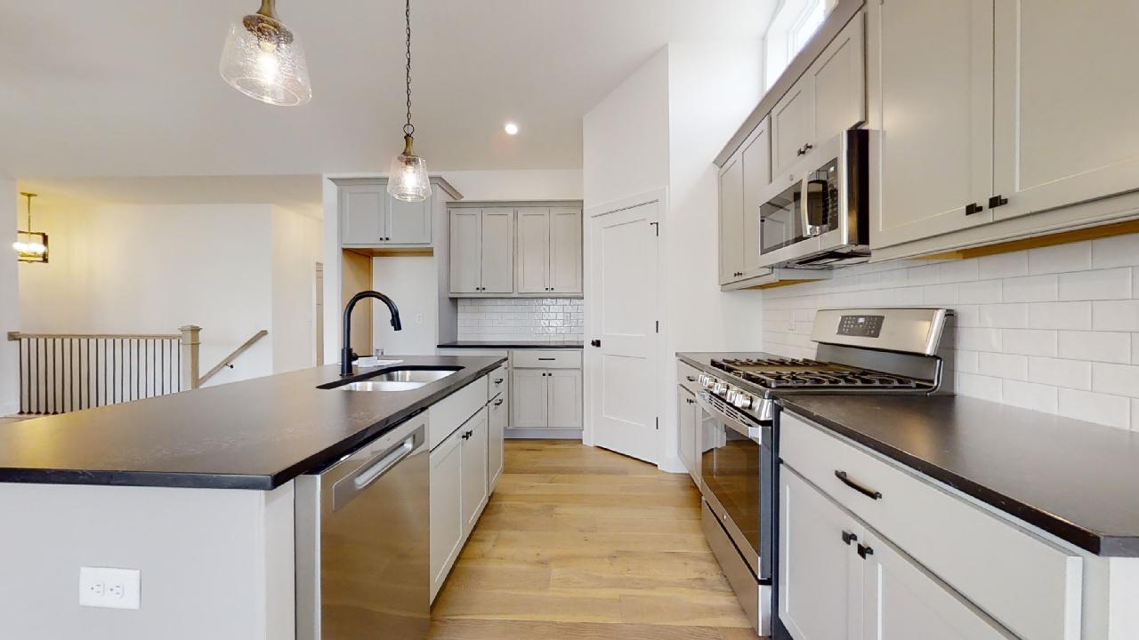 3910 Bay Circle Champaign, IL 61822 - Photo 11 of 49 a kitchen with stainless steel appliances granite countertop a stove a sink dishwasher and a refrigerator
