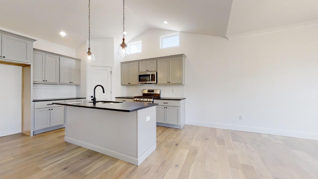 3910 Bay Circle Champaign, IL 61822 - Photo 10 of 49 a kitchen with stainless steel appliances granite countertop a sink a stove a refrigerator and island with wooden floor