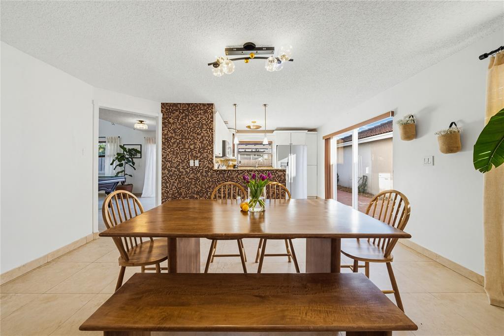 14277 Southwest 177th Street Miami, FL 33177 - Photo 12 of 38 a view of a dining room with furniture
