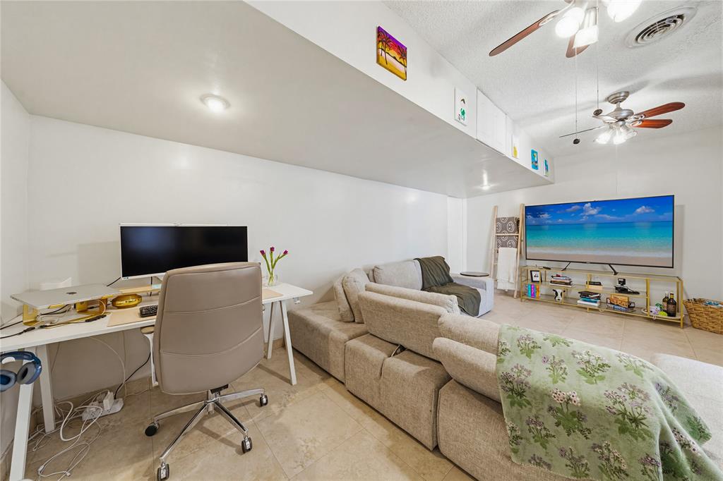 14277 Southwest 177th Street Miami, FL 33177 - Photo 15 of 38 a living room with furniture and a flat screen tv
