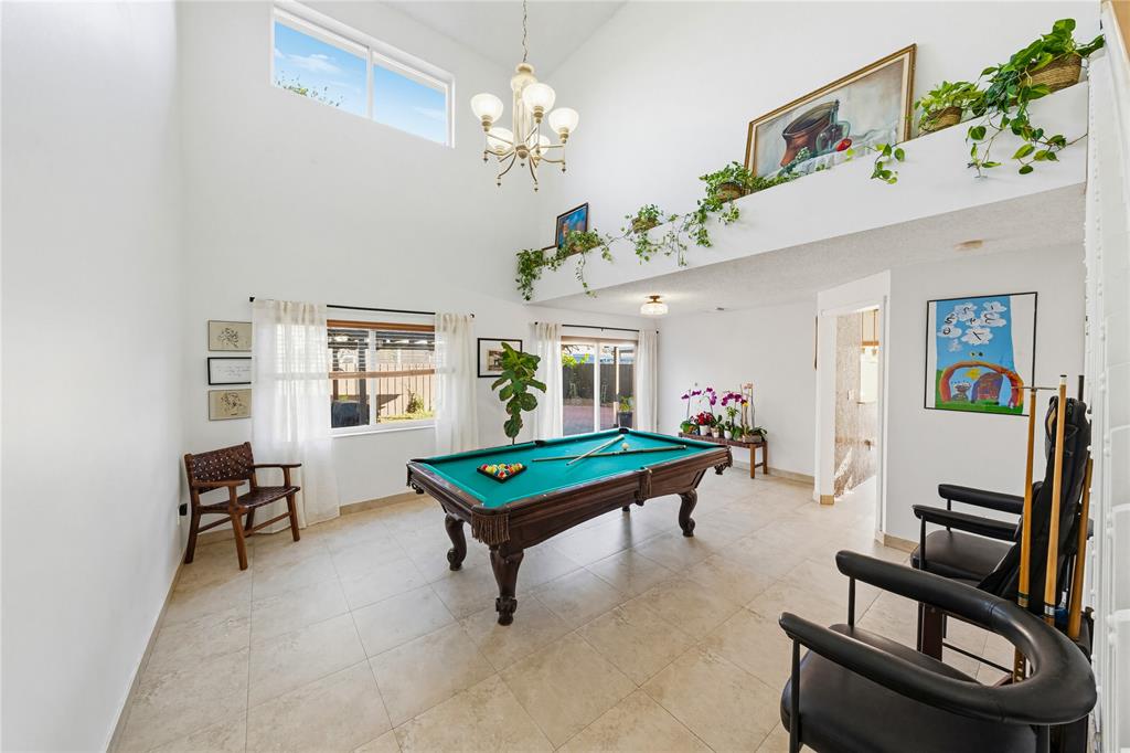 14277 Southwest 177th Street Miami, FL 33177 - Photo 5 of 38 a living room with furniture and a chandelier