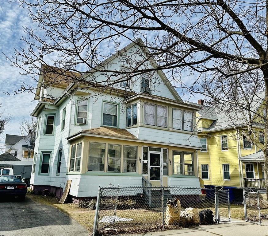 a front view of a residential apartment building with a yard