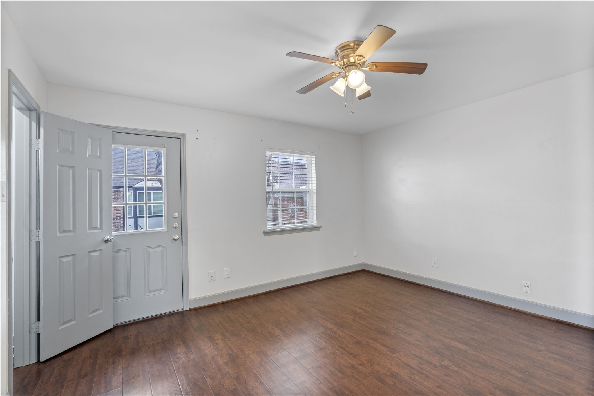 1271 Witte Road, Unit 26 Houston, TX 77055 - Photo 15 of 27 an empty room with wooden floor chandelier fan and windows