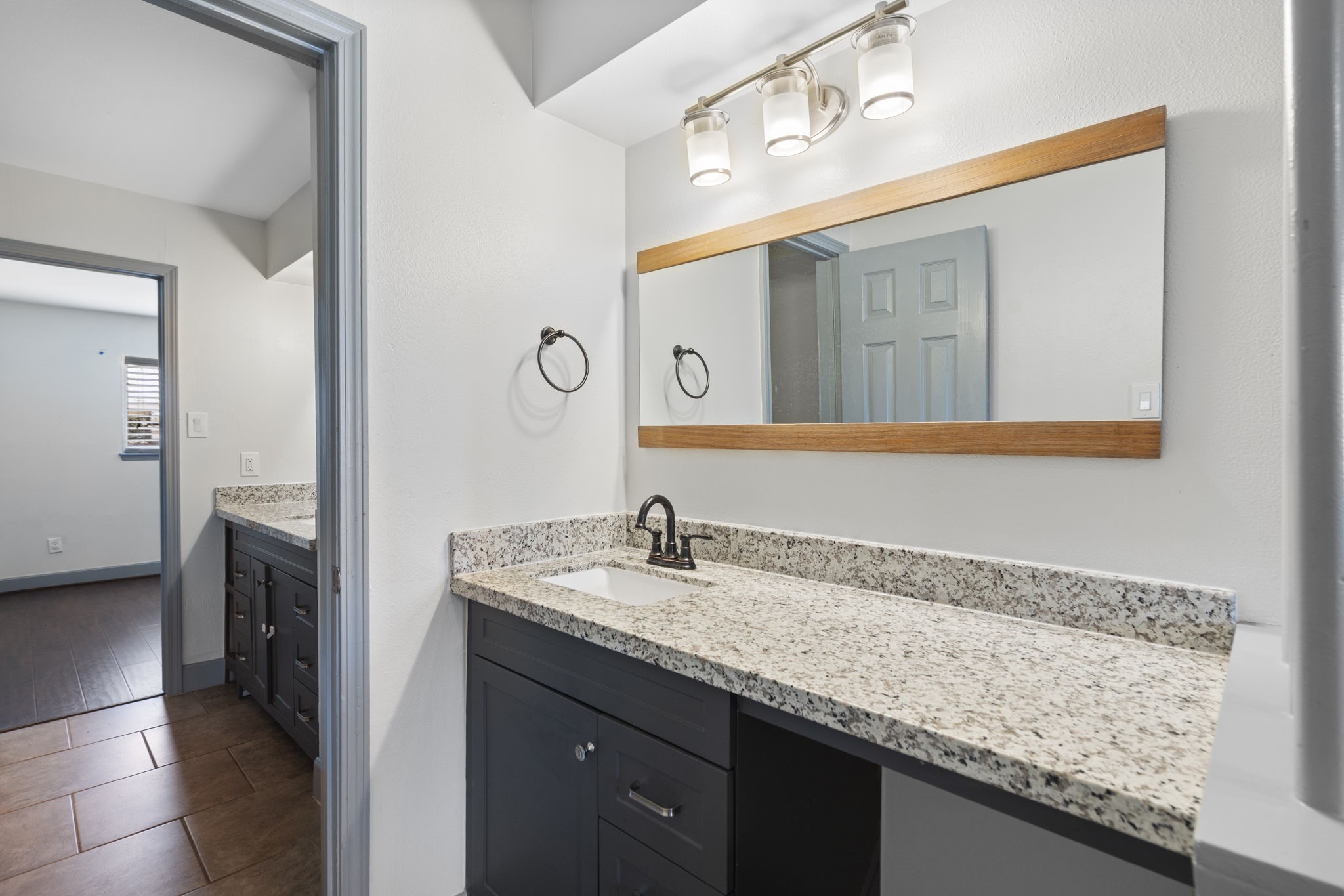 1271 Witte Road, Unit 26 Houston, TX 77055 - Photo 19 of 27 a bathroom with a granite countertop sink and a mirror
