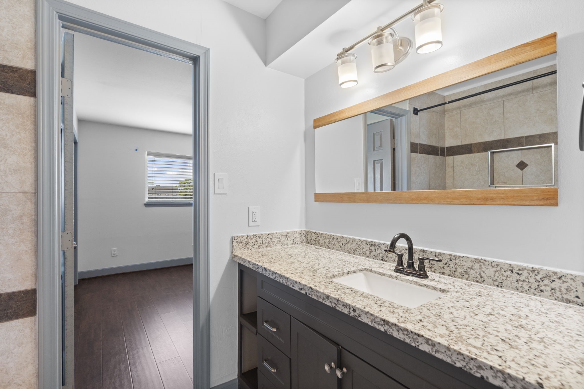 1271 Witte Road, Unit 26 Houston, TX 77055 - Photo 20 of 27 a bathroom with a granite countertop sink and a mirror