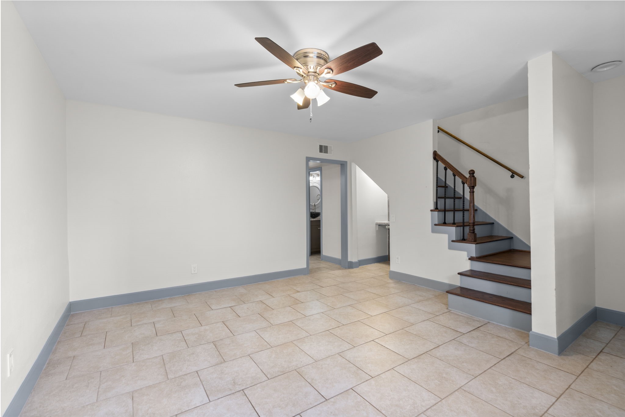 1271 Witte Road, Unit 26 Houston, TX 77055 - Photo 4 of 27 a view of an empty room with stairs and a ceiling fan