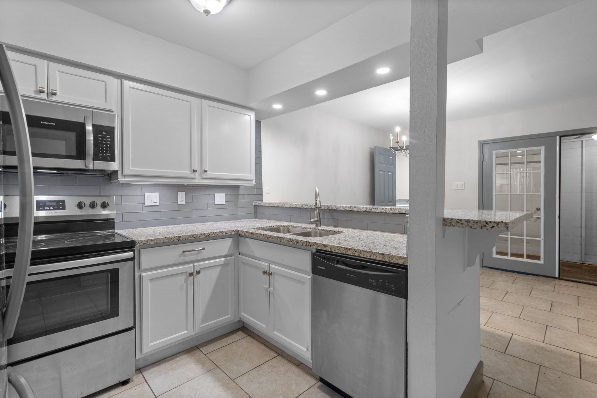 1271 Witte Road, Unit 26 Houston, TX 77055 - Photo 6 of 27 a kitchen with stainless steel appliances granite countertop a stove and a microwave