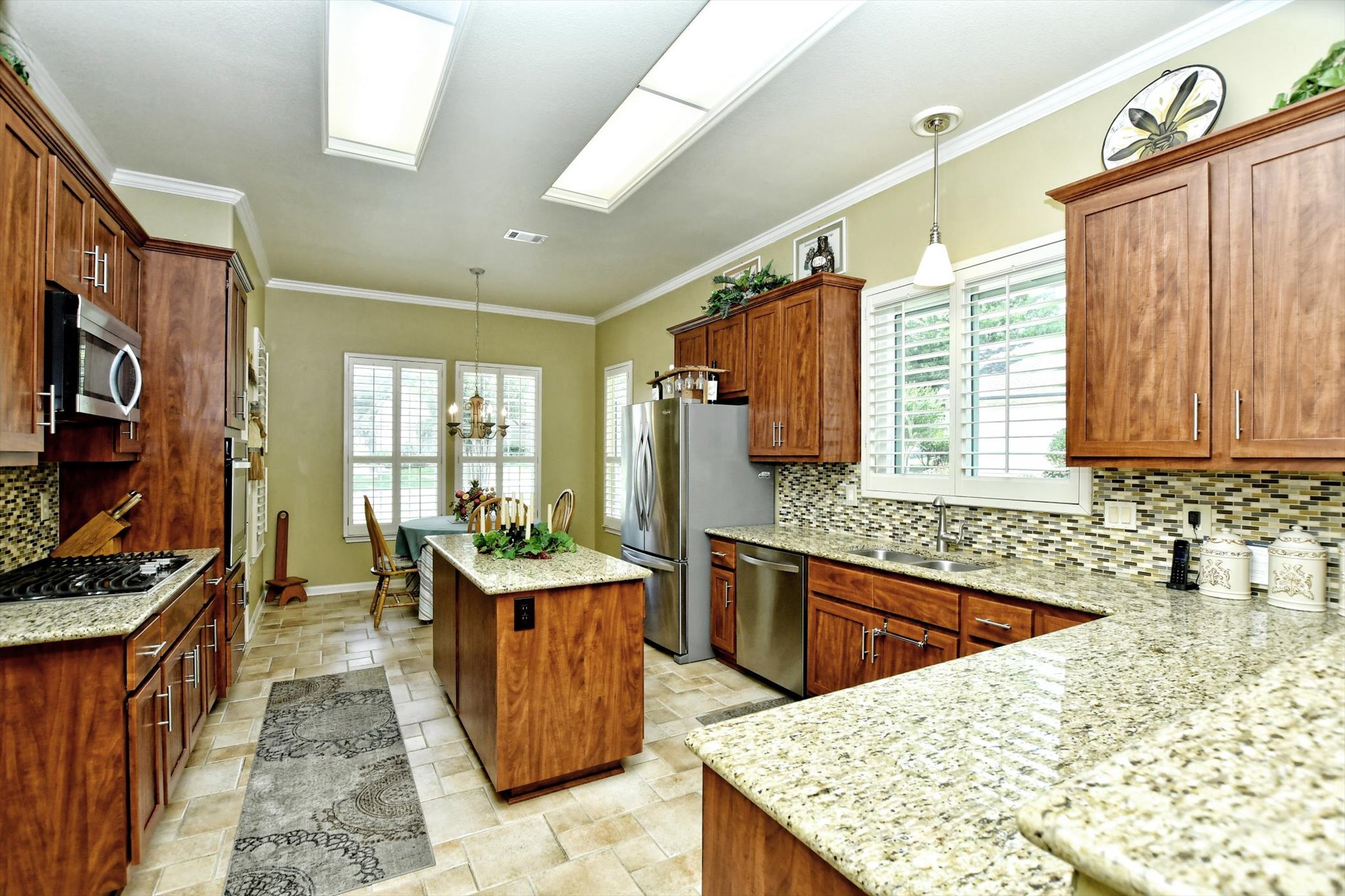106 Nighthawk Way Georgetown, TX 78633 - Photo 10 of 29 Culinary delights await in this well-lit kitchen featuring rich cabinetry and a central island.