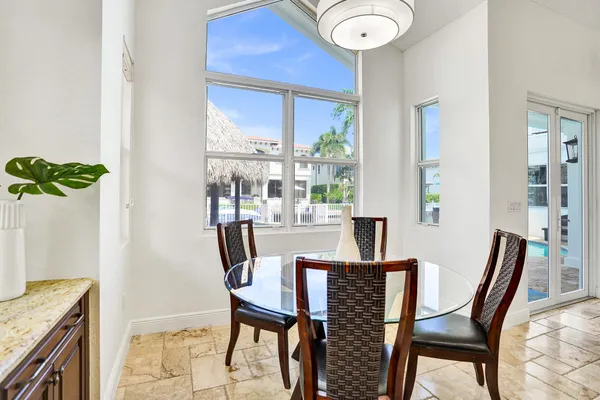 a view of a kitchen with kitchen island granite countertop a sink a counter top space and living room view