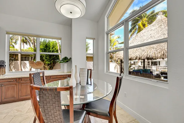a kitchen with a table chairs sink and cabinets