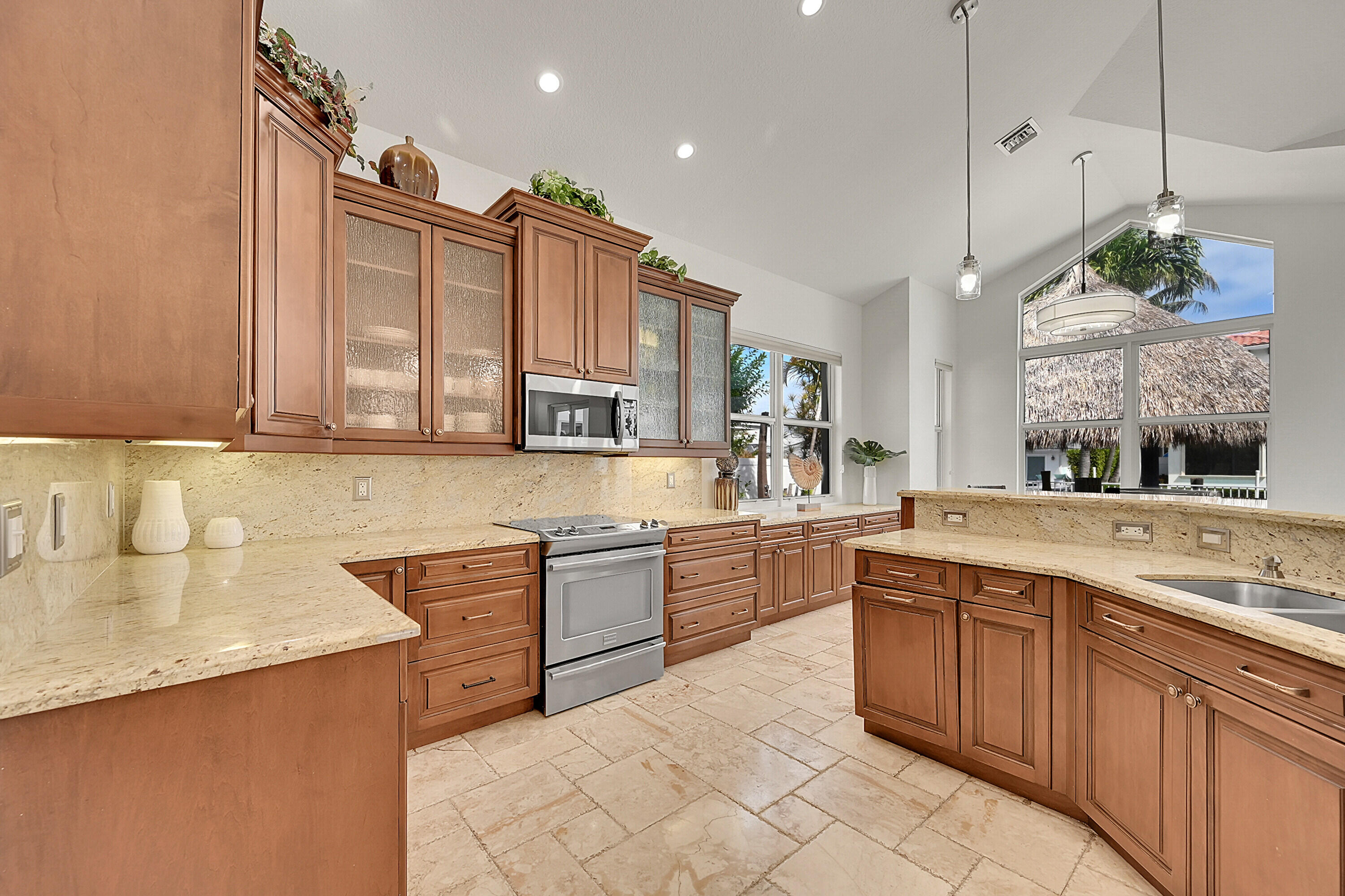 785 Northeast 71st Street Boca Raton, FL 33487 - Photo 16 of 62 a large kitchen with stainless steel appliances granite countertop a sink and a stove