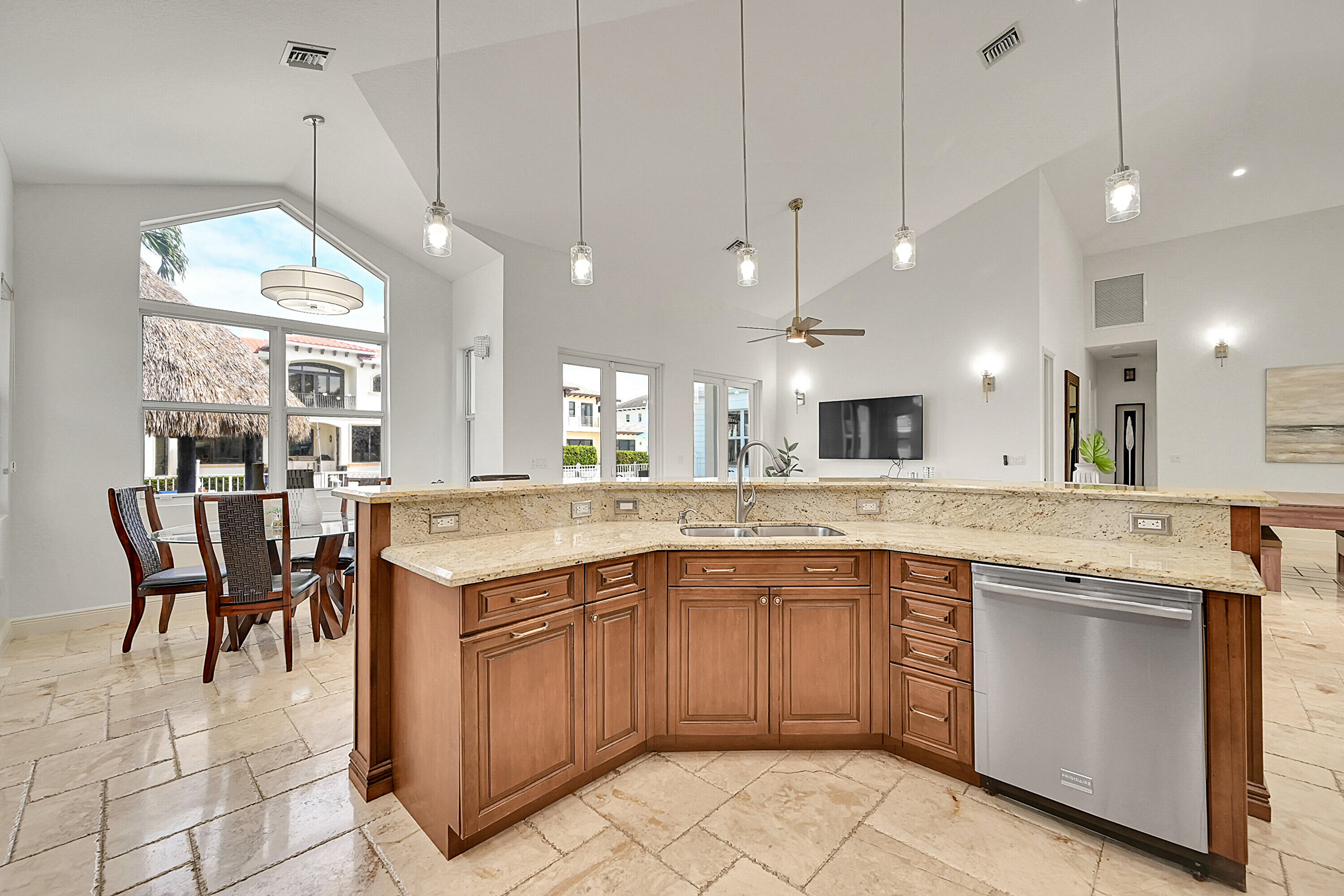 785 Northeast 71st Street Boca Raton, FL 33487 - Photo 17 of 62 a large kitchen with a sink and living room view