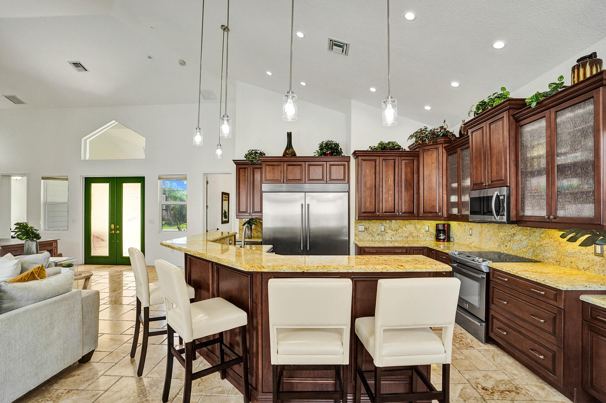 785 Northeast 71st Street Boca Raton, FL 33487 - Photo 19 of 62 a kitchen with a table chairs sink and cabinets