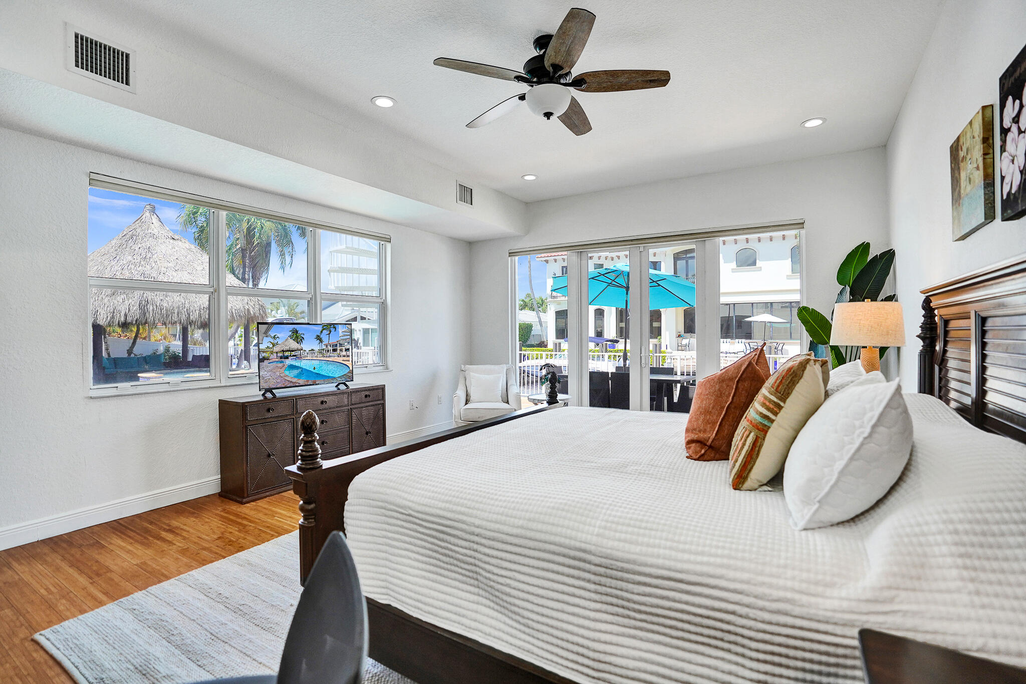 785 Northeast 71st Street Boca Raton, FL 33487 - Photo 25 of 62 a bedroom with a bed a large window with table and chairs
